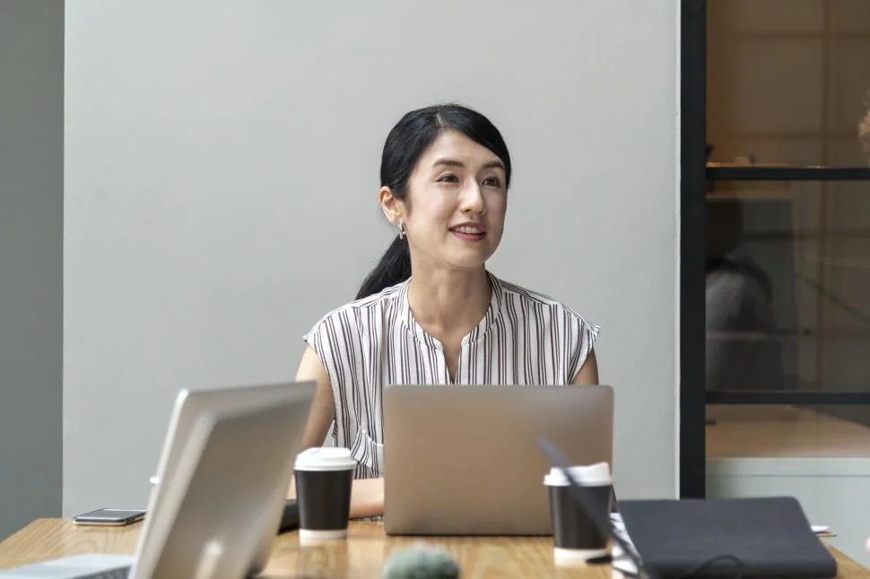 asian-professional-working-laptop-office-desktop